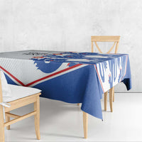 Blue and white lion print tablecloth with red-trim border, draped over table edge.