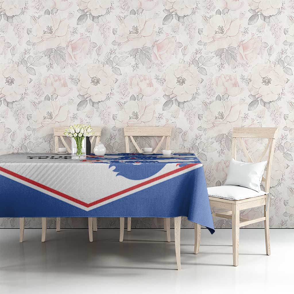 Football tablecloth with blue lion print and red/white border on dining table.