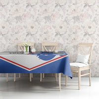 Football tablecloth with blue lion print and red/white border on dining table.