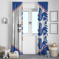 Two window curtain panels in blue and white with lion crest motifs and red border