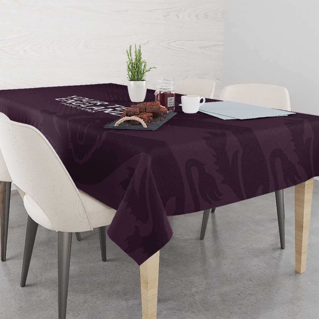 Purple football tablecloth on a dining table with cups and decor items