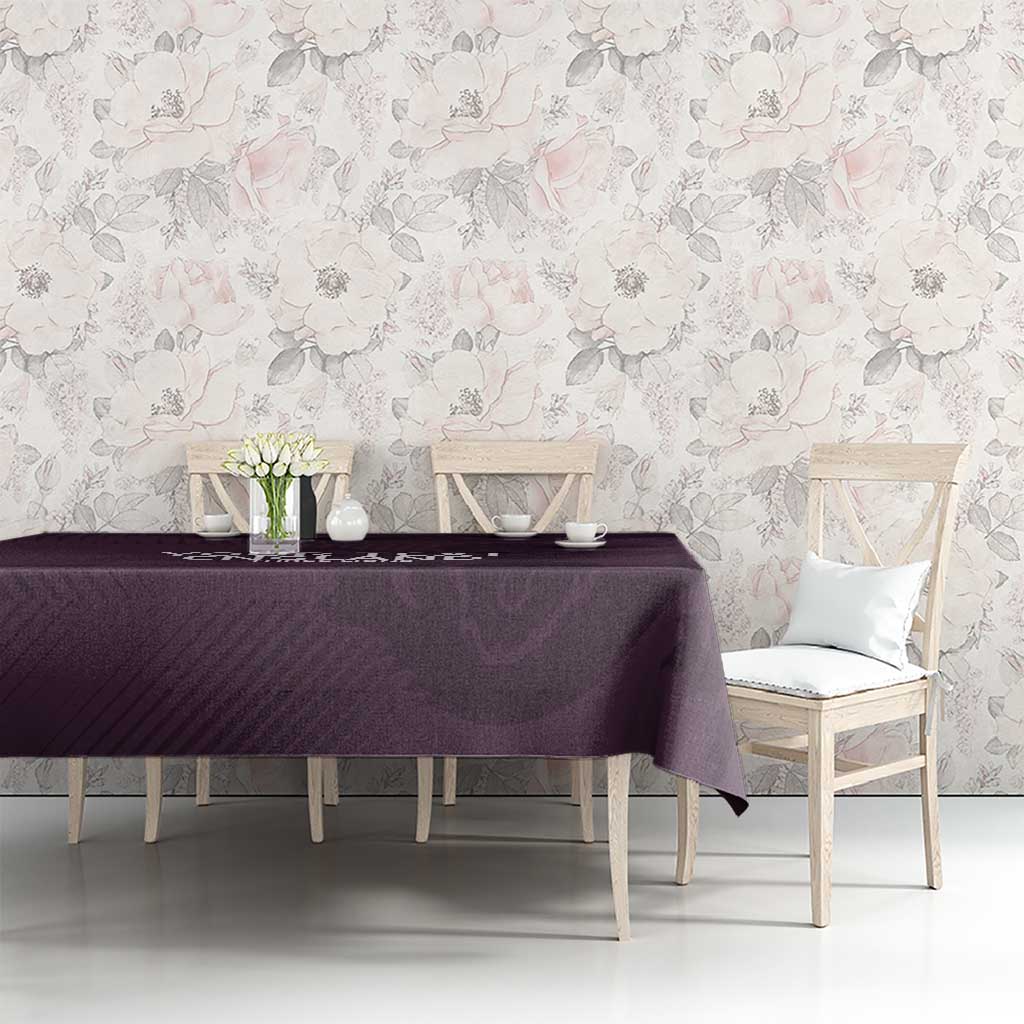 Purple football tablecloth on a long dining table with two light chairs visible