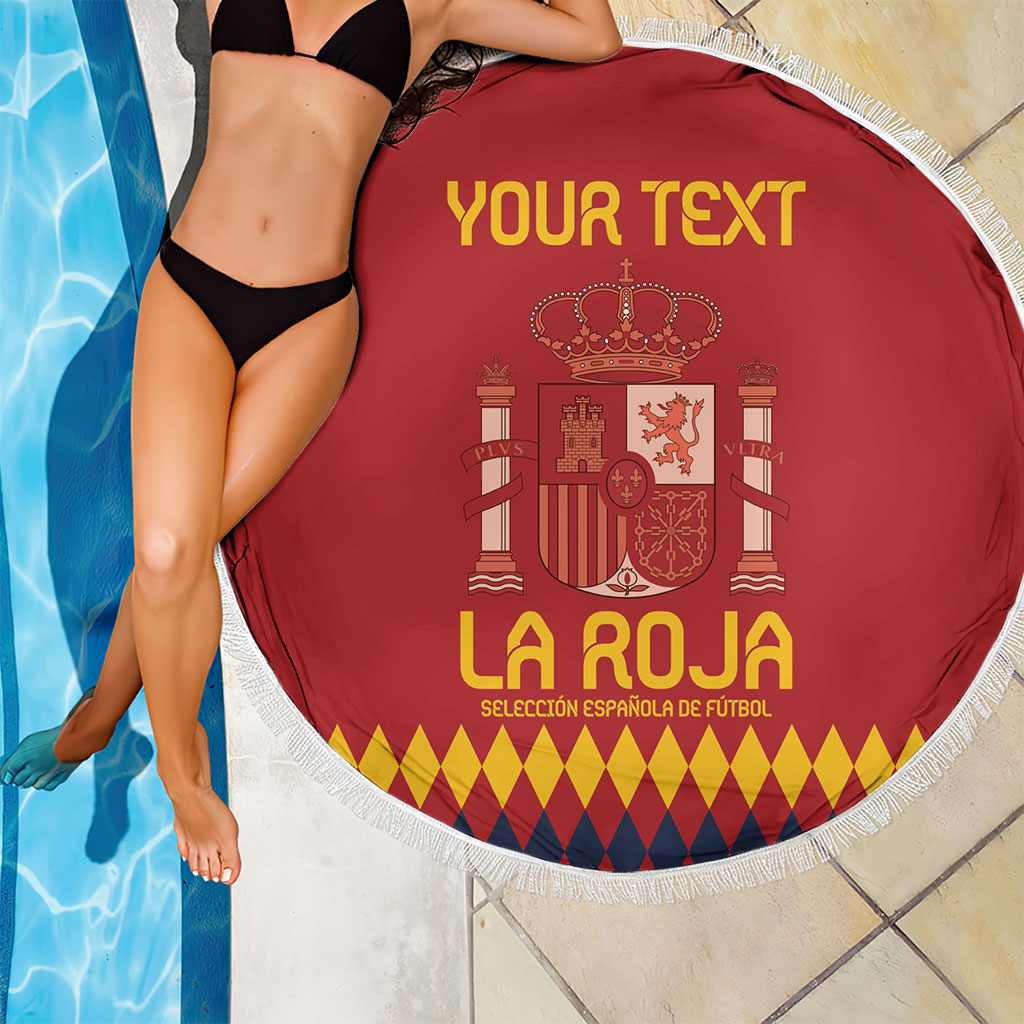 Red round beach blanket with white fringe edge, Spain crest, and 'YOUR TEXT'.