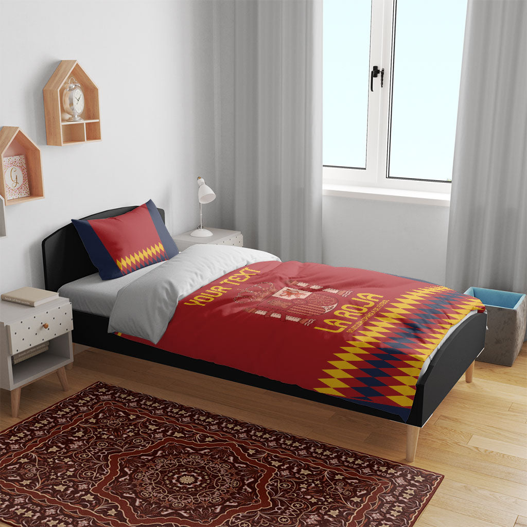 Red and navy bedding set with crest and yellow diamond trim on a wooden bed
