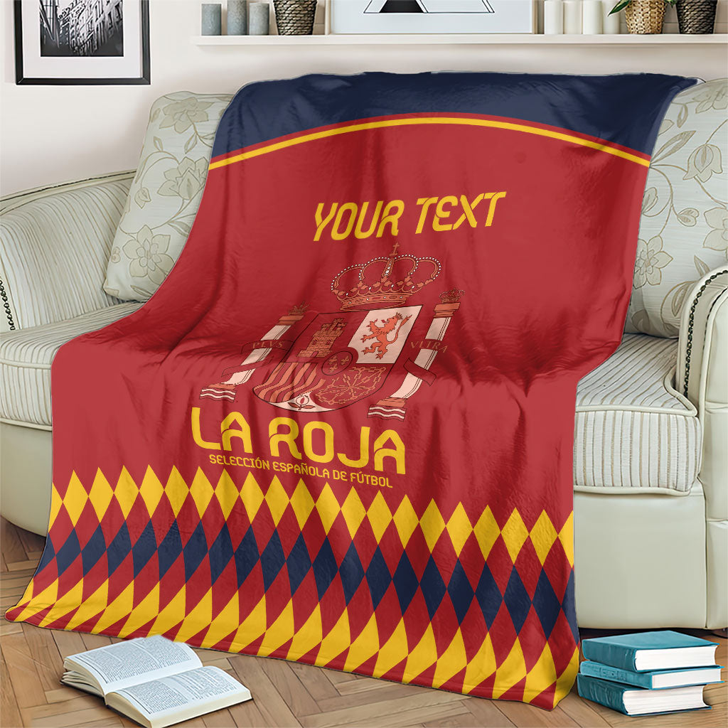 Spain football blanket draped on sofa, red and navy crest design with diamond hem