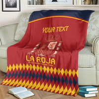 Spain football blanket draped on sofa, red and navy crest design with diamond hem