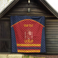 Navy blue Spain football quilt hung on wall, red center crest and gold text