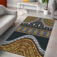 Tribal pattern area rug, dark base with gold, orange, and green geometric motifs