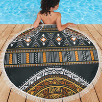 Round beach blanket with tribal geometric center medallion, black and gold, white fringe