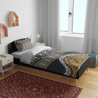 Charcoal duvet cover and two pillowcases with gold and orange geometric tribal design.