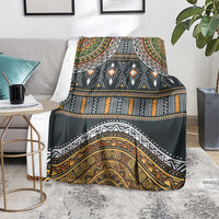 Ethnic tribal pattern blanket over a chair in dark gray with gold and teal accents