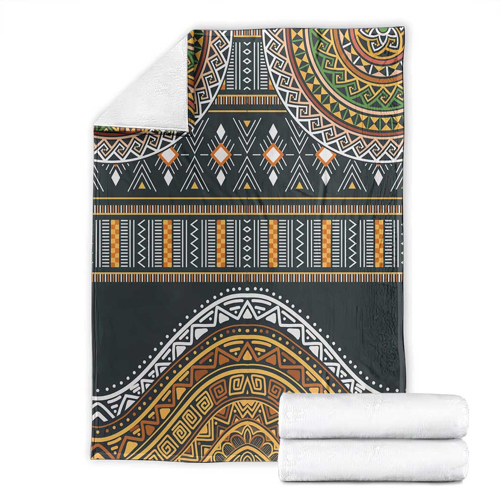 Folded ethnic geometric blanket in dark gray with gold, orange, teal, and white pattern