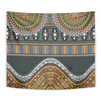 Close-up wall tapestry showing dark gray fabric with gold, orange, green patterned bands