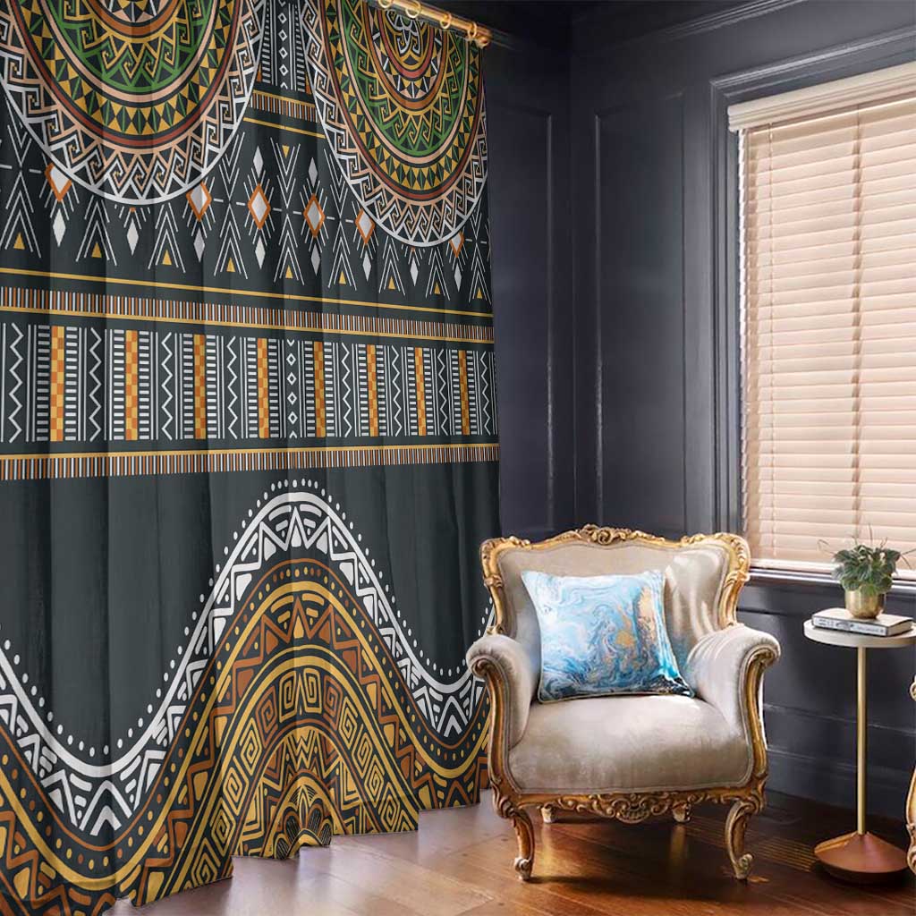 Ethnic window curtain with dark fabric and layered gold, green, white geometric motifs.