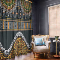 Ethnic window curtain with dark fabric and layered gold, green, white geometric motifs.