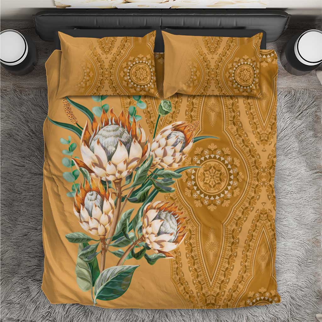 Gold bedding set with protea flower and ornate dashiki motif on matching pillowcases