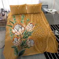 Gold bedding set with protea bouquet on front panel and ornate circular medallion on side