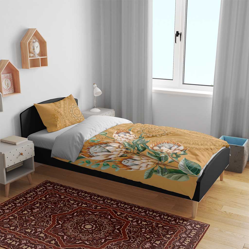 Gold duvet and pillowcases with protea bouquet and ornate medallion pattern