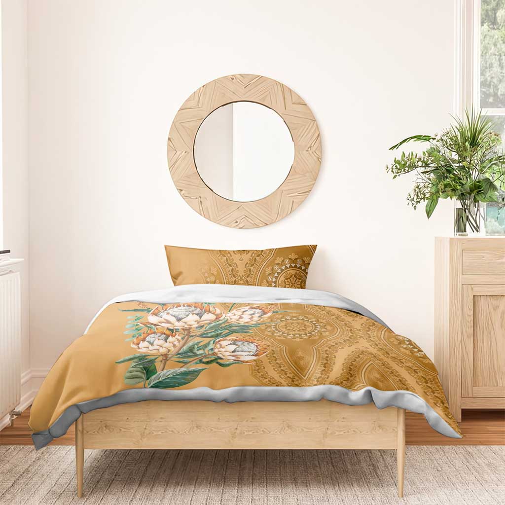 Gold duvet with protea bouquet print and paisley-style ornate pattern, with matching pillow