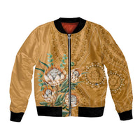 Gold unisex bomber jacket with zip front, black ribbed hem, and protea motif panel