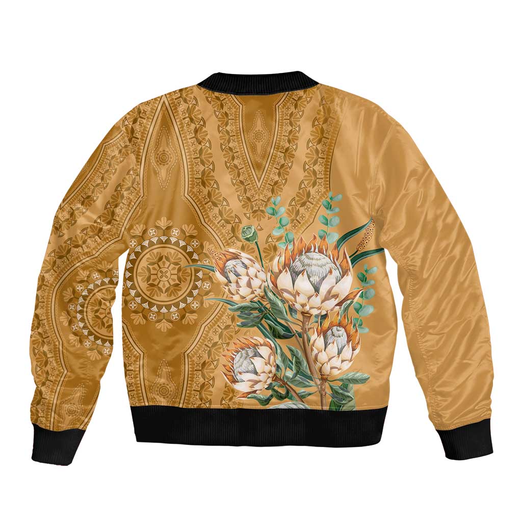 Gold unisex bomber jacket with black collar and cuffs, back paisley pattern with protea bouquet