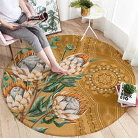 Round gold carpet with proteas and leafy vines, ornate border and central medallion