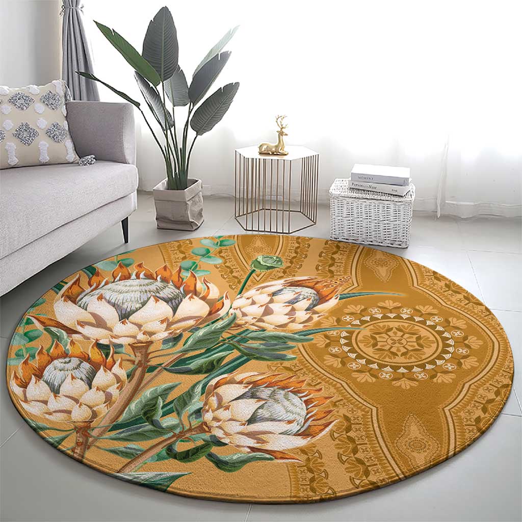 Round gold proteas dashiki motif carpet on floor with detailed center medallion pattern