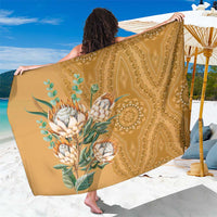 Gold dashiki-motif sarong with floral medallion print, draped as a wrap