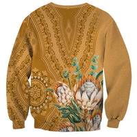 Gold crewneck sweatshirt with back dashiki motif and centered flower-and-leaf artwork