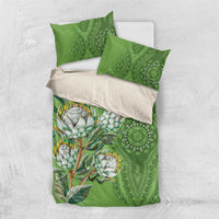 Green bedding set with protea floral print and matching pillow covers