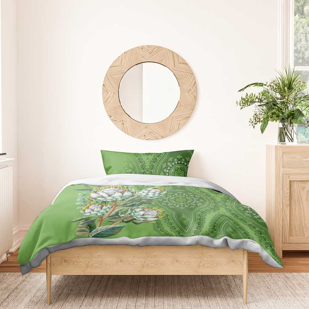 Green bedding set with protea bloom illustration and circular motif center panel