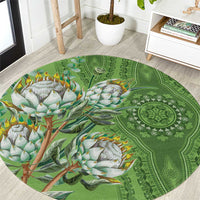 Green round carpet with ornate mandala pattern and colorful bird-and-flower motif