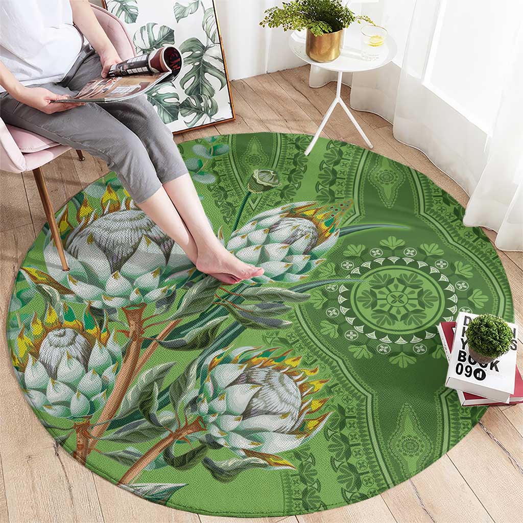 Green round carpet featuring mandala details and bird branch print with orange accents
