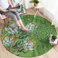 Green round carpet featuring mandala details and bird branch print with orange accents