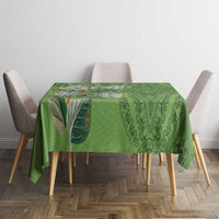 Green dashiki motif tablecloth with repeating ornamental pattern on dining table