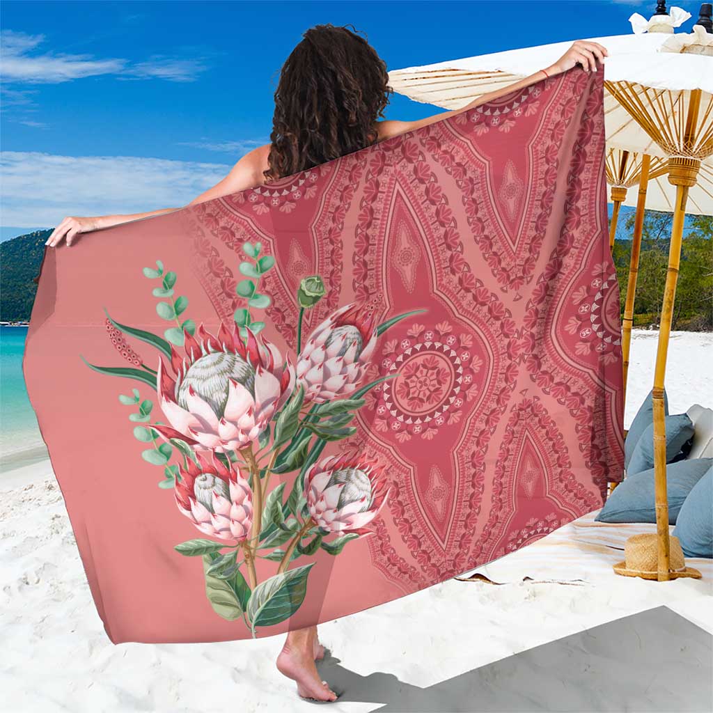 Printed sarong with paisley and protea-style floral dashiki motif, rose-peach drape