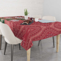 Peach dashiki motif tablecloth draped on dining table with protea floral accents