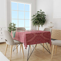 Peach dashiki motif tablecloth on dining table with leafy protea floral pattern