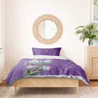 Violet bedding set with protea flowers and purple dashiki medallion print, neatly made bed