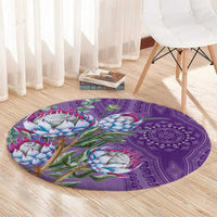Violet round rug with protea floral motif and purple medallion design