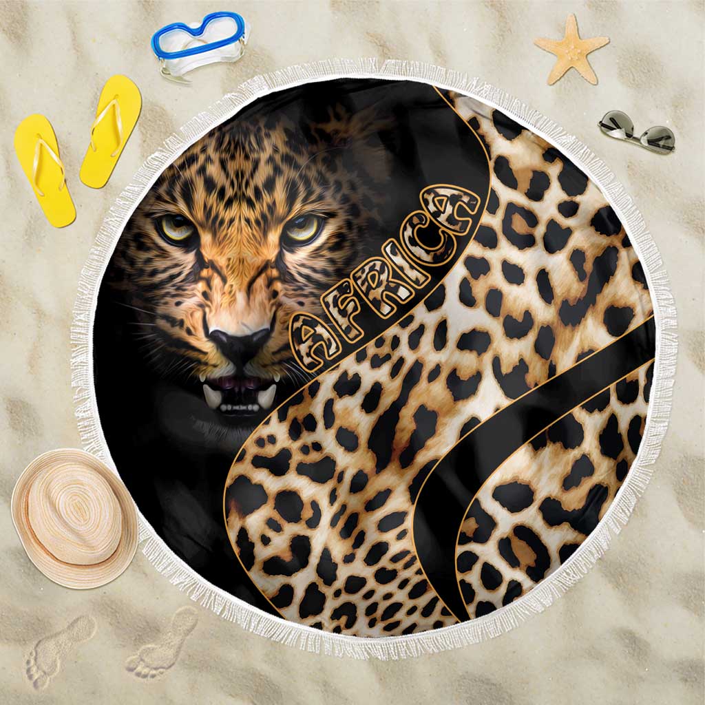 Round leopard-print beach blanket with lion face center, black accents, and white fringe