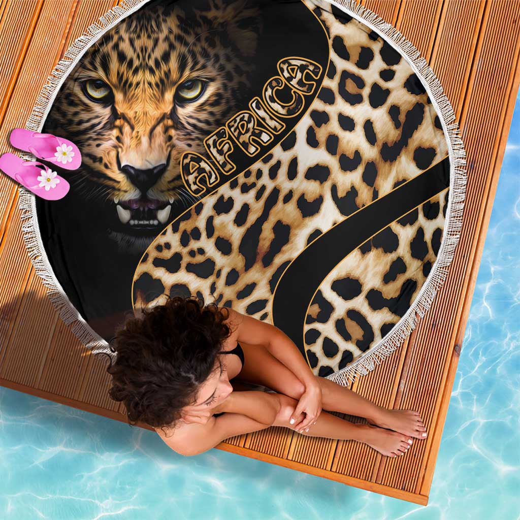 Leopard-pattern round beach blanket with lion face, black swoosh detail, and white fringe