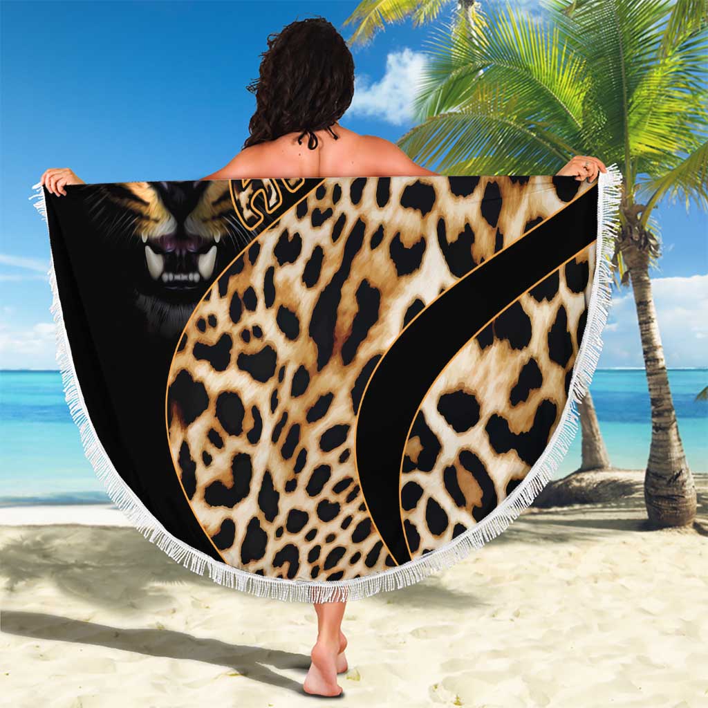 Round leopard-print beach blanket with lion face artwork, black edge, and white tassel fringe