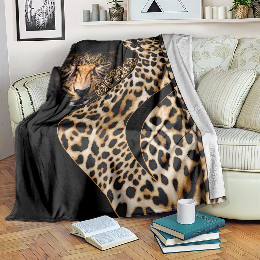 Black and gold leopard-pattern blanket with cat face and curved script detail