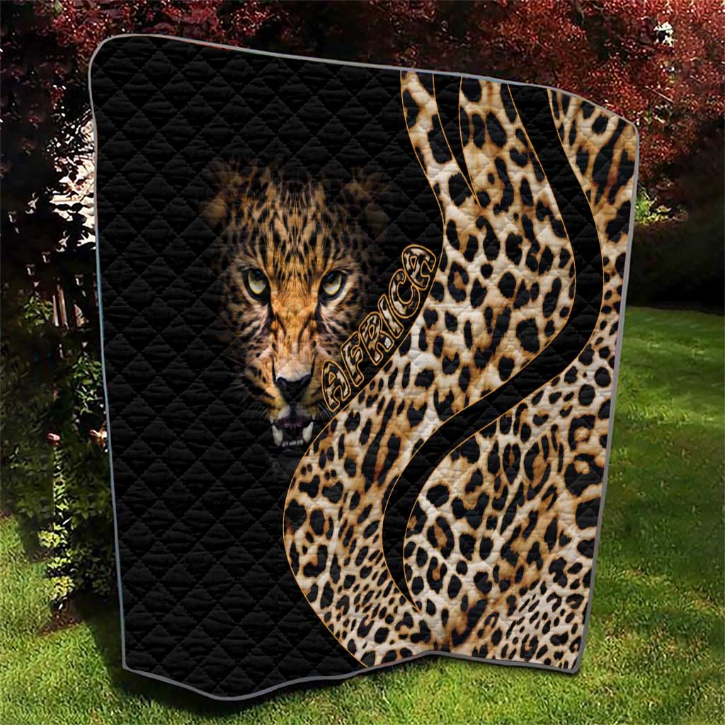Black quilt with leopard face and tan-and-brown spotted pattern, diamond-quilted texture
