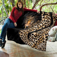 Leopard-themed black quilt with tan tiger face and large spots, soft blanket with stitched texture