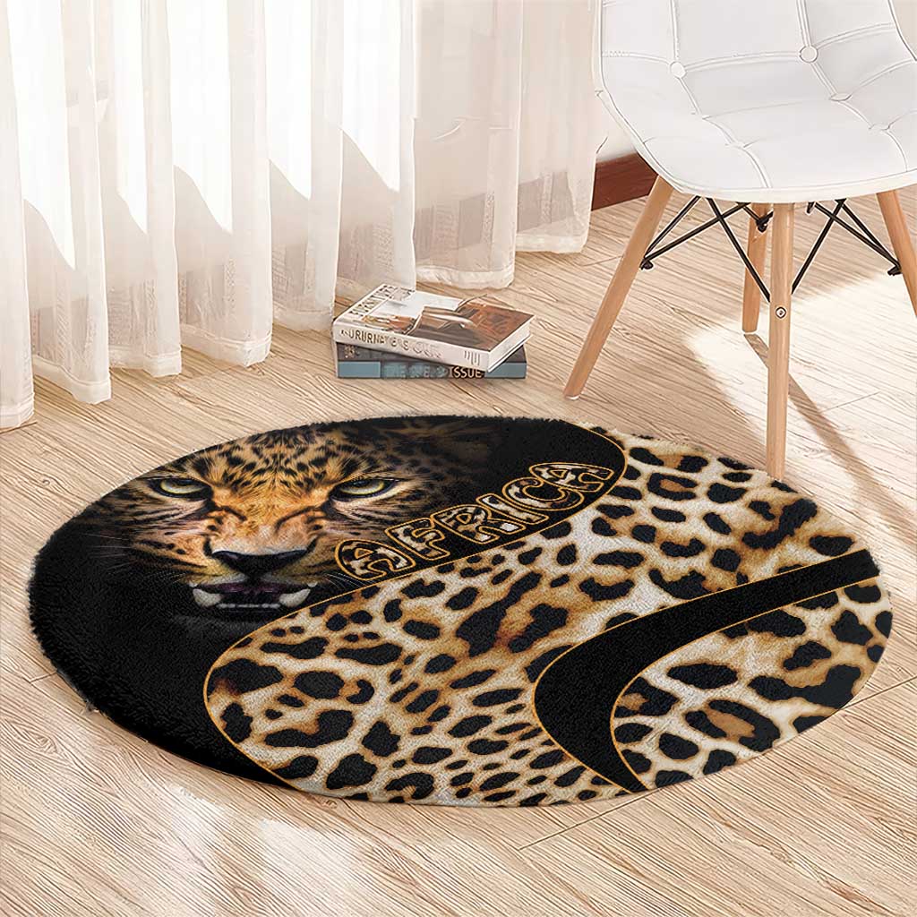 Round leopard-print carpet with cat face and tan spots on black, with decorative emblem.