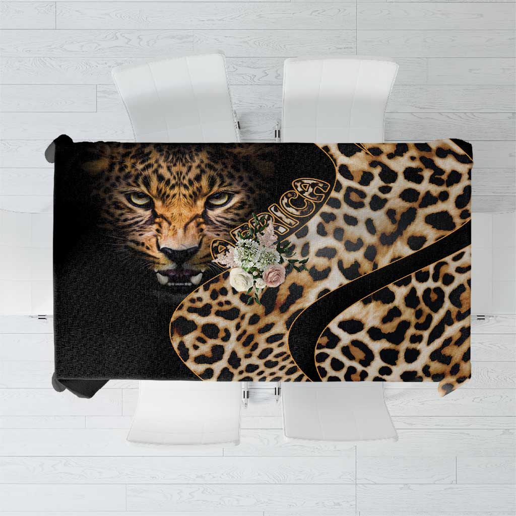 African leopard skin pattern tablecloth, black and tan with curved decorative border.