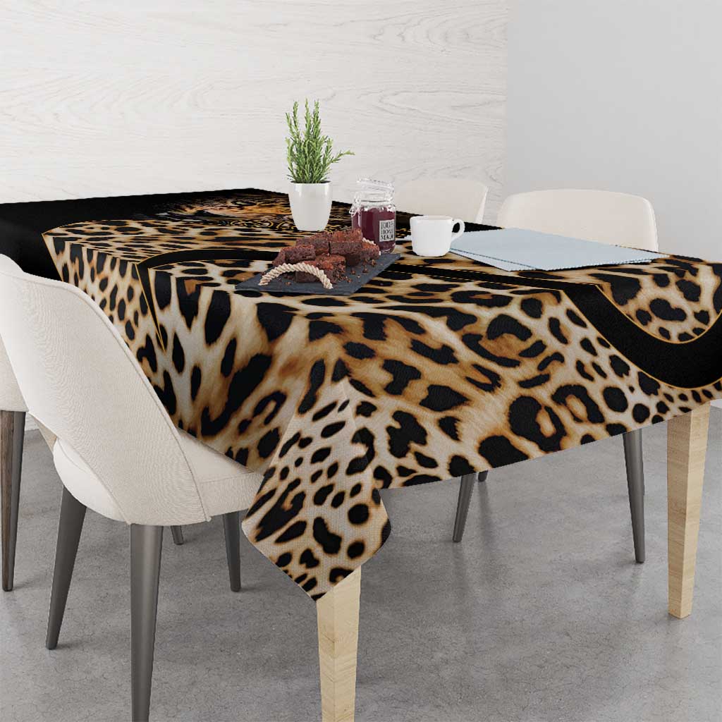 African leopard skin pattern tablecloth on dining table with scalloped black corner edge.