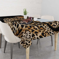 African leopard skin pattern tablecloth on dining table with scalloped black corner edge.